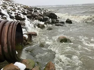 Water pours our of a pipe into the Back Cove.