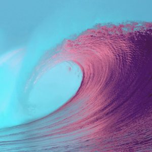 pink colored ocean wave against blue sky