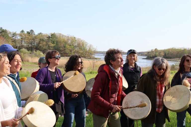 Jen and Drummers at the Watershed Ceremony with the Presumpscot River in the background.