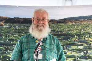 Joe wearing green short with green eelgrass backdrop