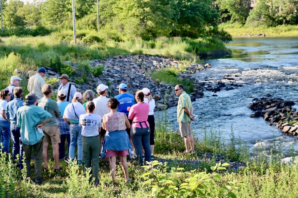 group gathers by a river