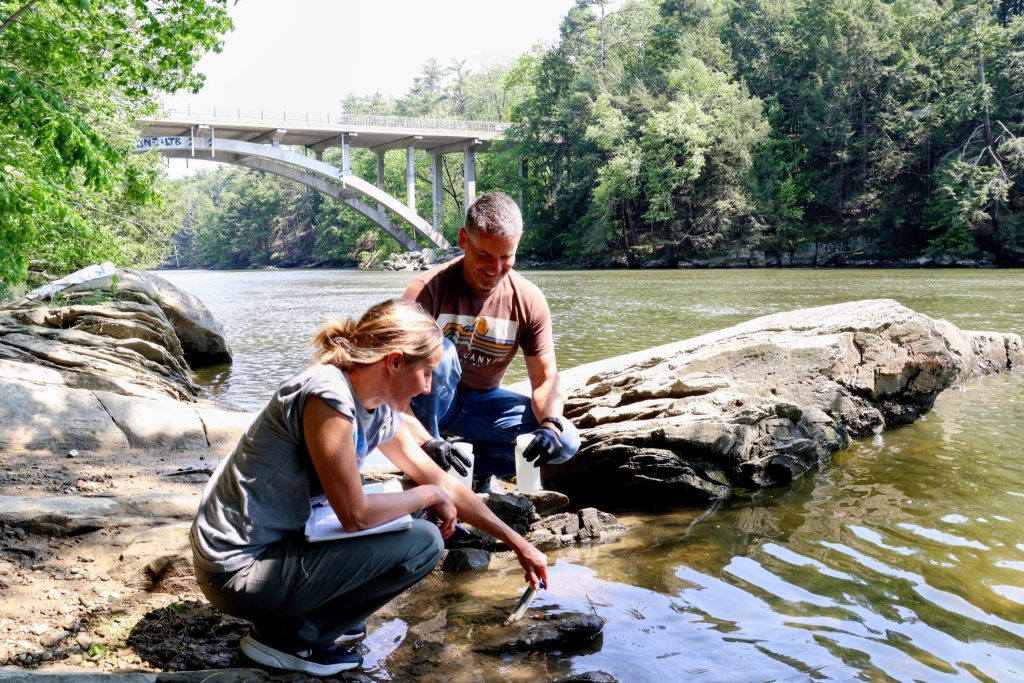Heather and MIke gather PFAS samples from the Presumpscot RIver