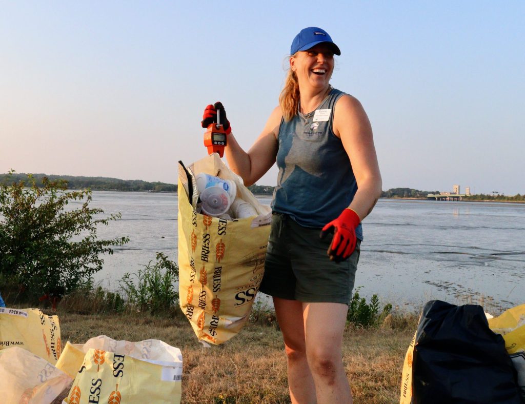 Katrina holds up a bag of trash
